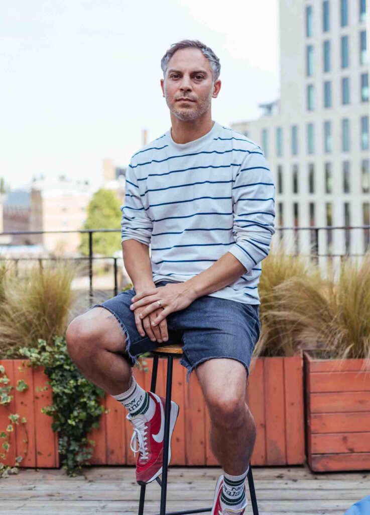 Man sat on stool outside