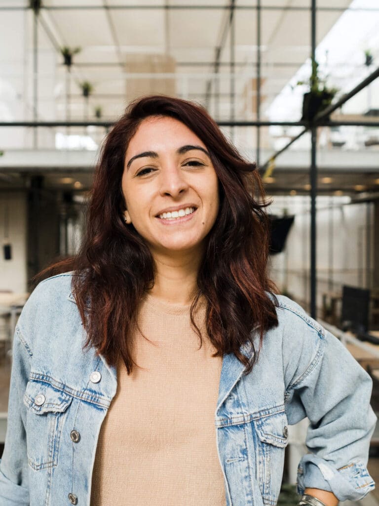 woman stood in office wearing jeans jacket